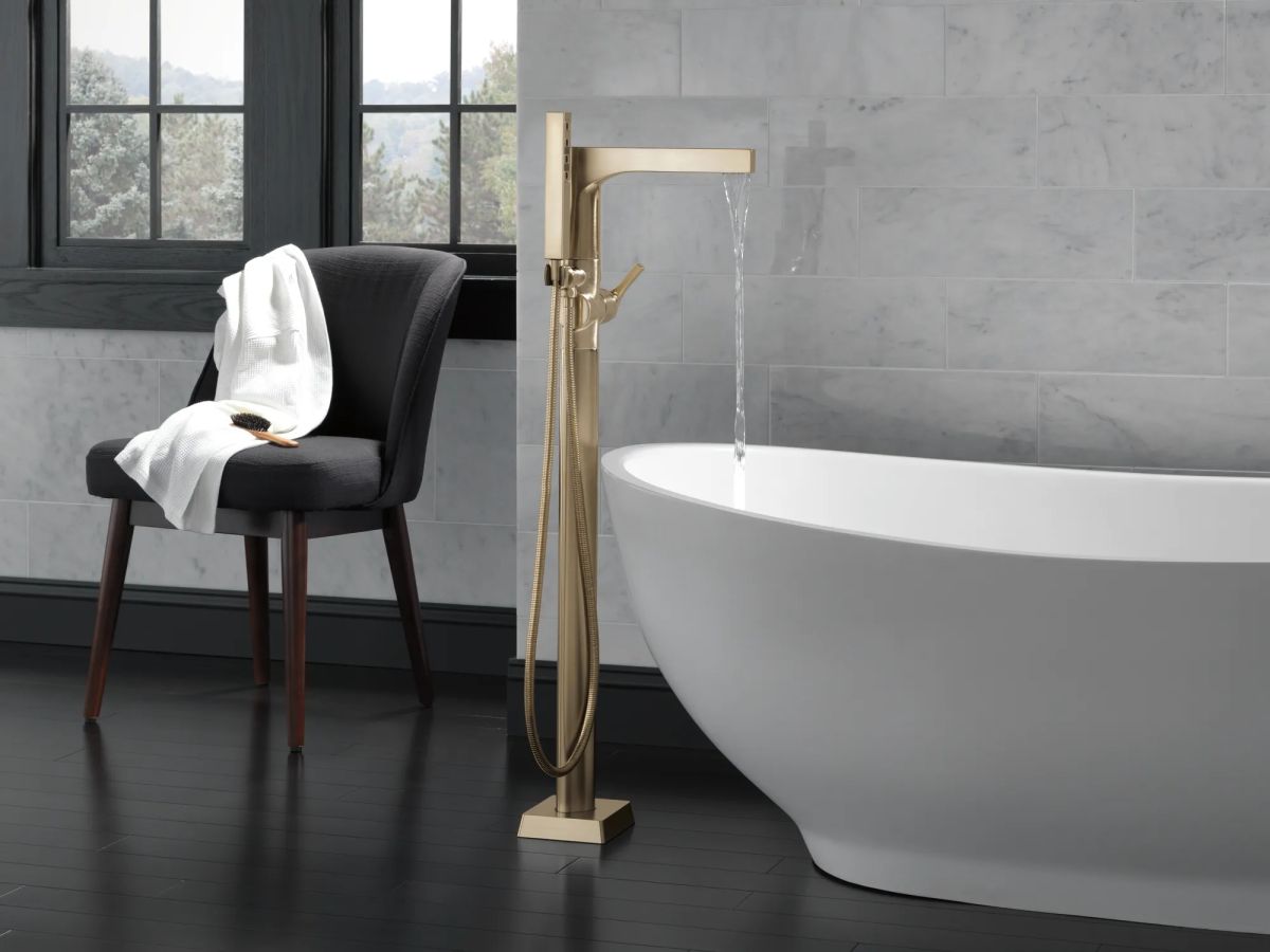 DELTA Zura Single Handle Floor Mount Tub Filler Trim with Hand Shower — Champagne Bronze